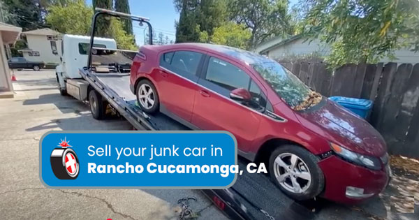 Junk car on a tow truck being removed in Rancho Cucamonga